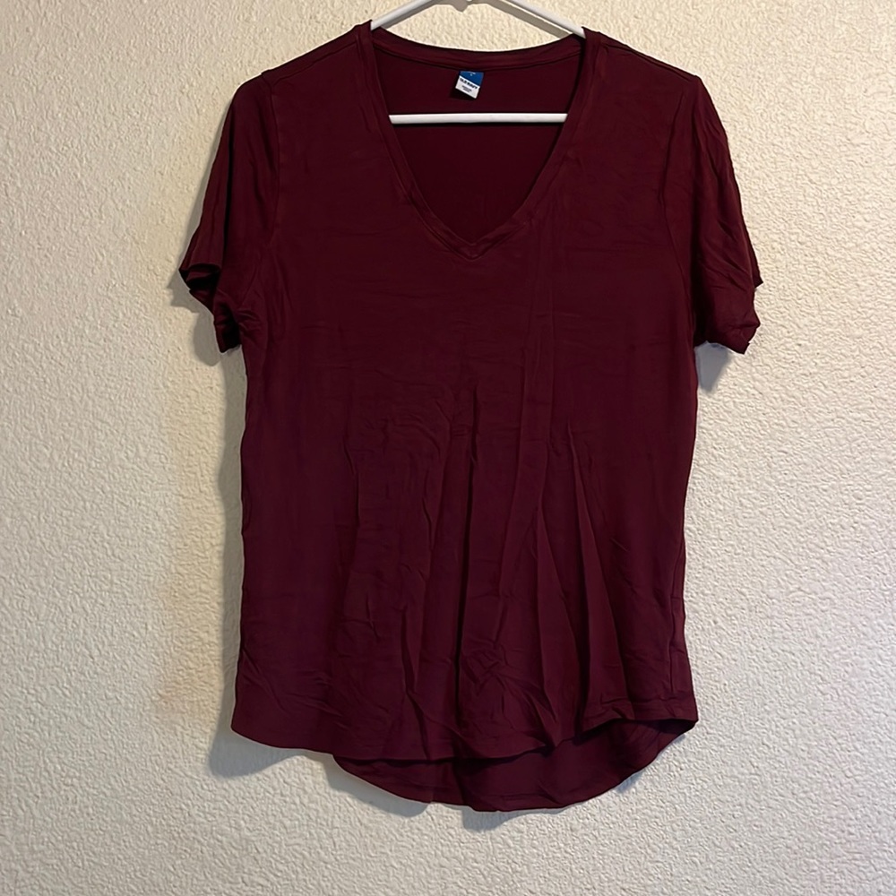 This is a Burgundy V-neck in a woman’s size small.